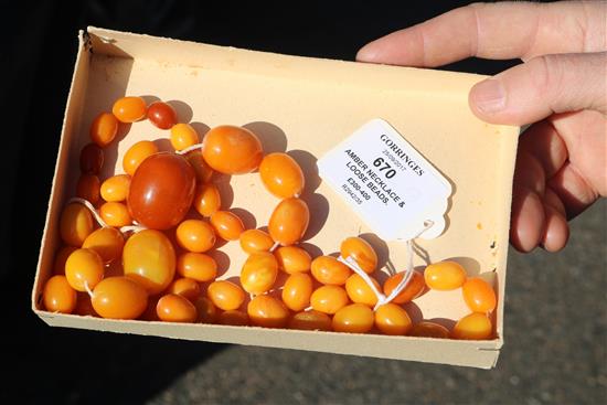 A single strand graduated amber bead necklace, including some loose beads,